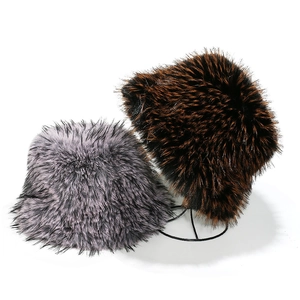 Detail showing two faux fox fur bucket hats in gradient grey and brown with long plush fibers