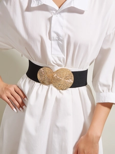 Close-up of wide elastic belt with gold double circle buckle and textured metal finish