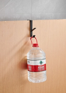Strong black metal over-the-door double hook holding 4kg weight on desk side