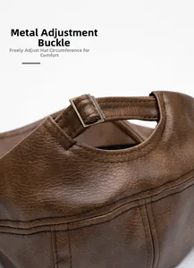 Detail of adjustable metal buckle and stitching on brown faux leather newsboy cap