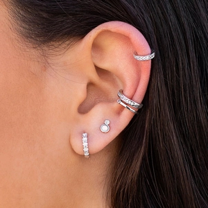 Elegant S925 silver stud earrings with opal and cubic zirconia in a stacked ear curation