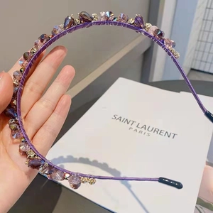 Detailed view of handmade headband featuring purple crystals and fine metal thread