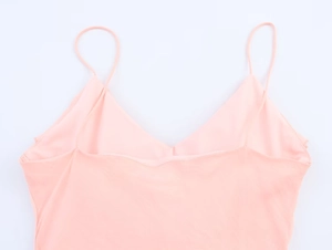 Detailed view of pink silk camisole midi dress with slim straps and V-neckline