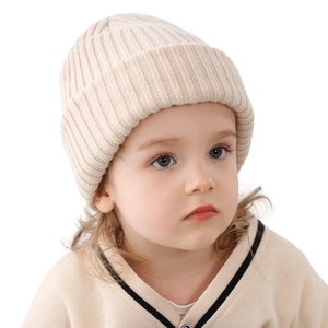 Warm beige ribbed knit beanie for children made of soft yarn for autumn and winter comfort