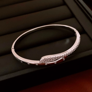 Macro shot of silver-tone overlapping cuff bracelet with pavé-set shimmering zircon stones