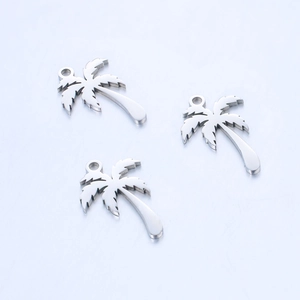 Macro shot of silver palm tree charms with polished mirror finish for DIY jewelry
