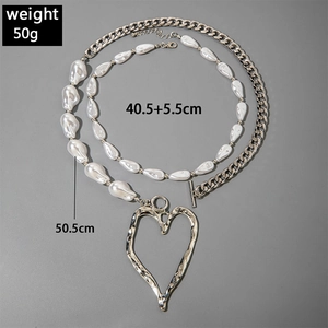 Detailed view of layered pearl necklace with heart pendant and length specifications