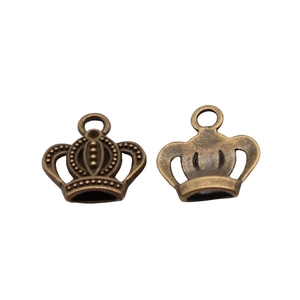 Macro detail of antique bronze crown pendants in alloy with circular hanging rings