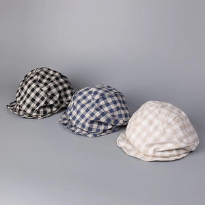 Detail view of cotton linen plaid beret caps in three vintage checkered patterns
