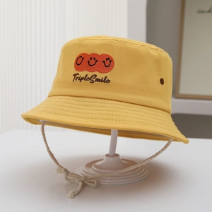 Detail of yellow cotton bucket hat featuring triple smile embroidery and adjustable chin cord