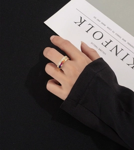 Detail of S925 silver rainbow ring with colorful baguette-cut stones on a model's hand