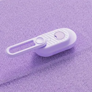Detail showing the purple pet massage brush with rotating handle and soft fiber cleaning pad