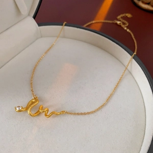 Detailed macro view of gold-plated snake pendant necklace with zircon in jewelry box