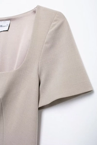 Close-up detail of khaki square neck short sleeve jacket with MWOMAN woven label