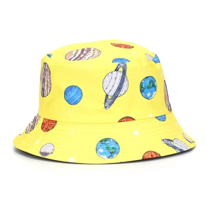 Detail of yellow bucket hat with space planet prints and reinforced stitching on the brim