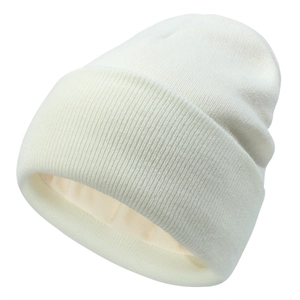 Close-up of the fine vertical ribbed texture and soft knit fabric of the white winter beanie