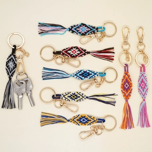 Handmade bohemian tasseled keychains with colorful geometric patterns and gold hardware