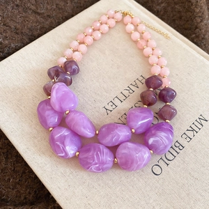Detail of double-layered acrylic beaded necklace with lavender marbled resin pendants