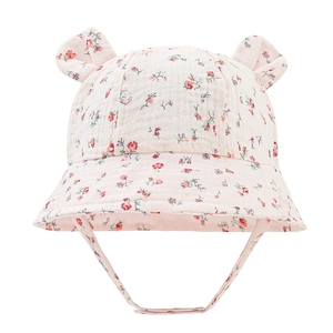 Detail of pink floral baby sun hat with cute bear ears and cotton crepe fabric texture