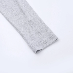 Close-up of grey raglan sleeves with thumbhole detail and knitted fabric texture