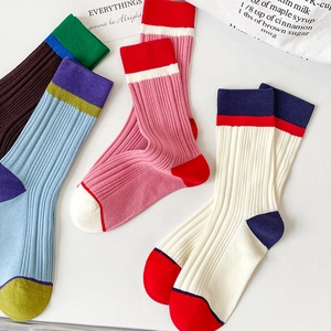 Detailed view of color-block ribbed cotton socks featuring vibrant multi-color stripe patterns