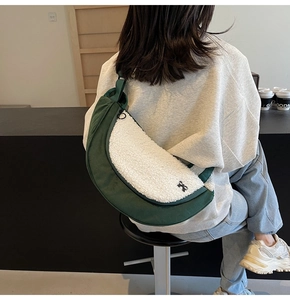 Detail of dark green canvas and white plush patchwork crossbody dumpling bag