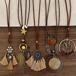 Five-piece bohemian tassel necklace set with vintage charms and wood beads on rope