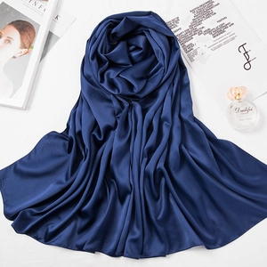 Silky dark blue Bawal scarf draped elegantly on a white surface with magazine and perfume
