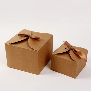 Minimalist kraft paper gift boxes with brown ribbon bows on a white background