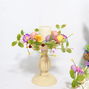 Close-up of Easter egg candle ring with spring flowers on a vintage ceramic base