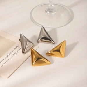 Macro shot of gold and silver 3D triangle earrings with high-polished metallic finish