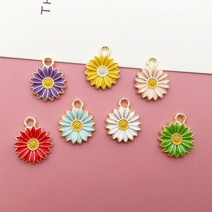 Detailed view of colorful enamel daisy charms in 7 vibrant shades for DIY jewelry making