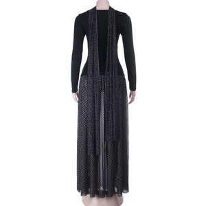 Detail of elegant black dress showing a sheer polka dot skirt and matching shawl back view