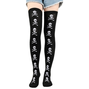 Detailed view of black over-the-knee socks with pirate skull and crossbones pattern