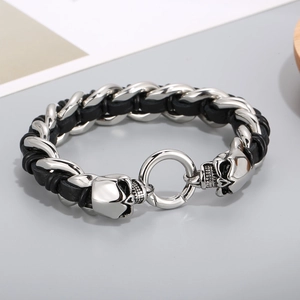 Close-up of braided leather strap with detailed stainless steel skull buckle design
