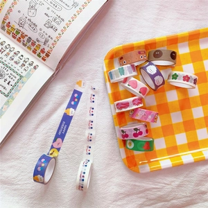 Detailed view of assorted cute washi tape rolls with bear and cloud patterns in a tray