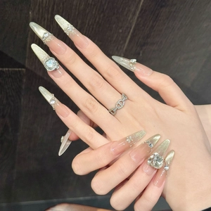 Sparkling cat-eye press-on nails with golden glitter gradient and large rhinestones