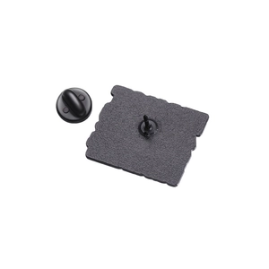 Detailed back view of enamel pin badge showing metal needle and black rubber clutch