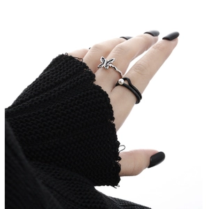 Gothic style silver butterfly ring and black multi-layer pearl ring on female hand