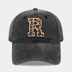 Detailed close-up of charcoal washed cotton baseball cap with leopard print letter R patch