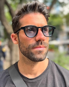 Detail shot of vintage round black sunglasses showing temple size 47 22-145 and lens tint