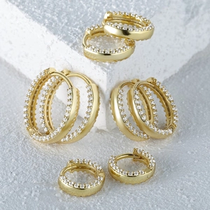 Detail of four sizes of gold S925 sterling silver hoop earrings with pavé cubic zirconia