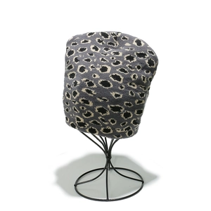 Winter leopard print knitted beanie hat in grey with black and white jacquard pattern