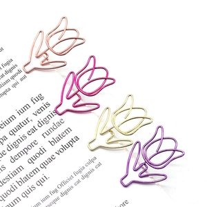 Macro view of tulip-shaped metal paperclips in rose gold, magenta, gold and purple colors