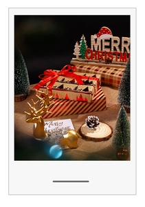 Close-up of Christmas gift boxes with gold reindeer decor and festive ribbon packaging