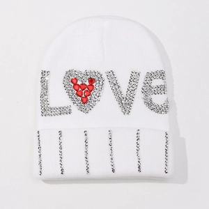 Detailed view of white knit beanie with rhinestone LOVE letters and red heart motif