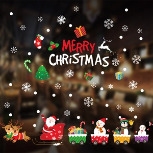 Christmas window stickers featuring Santa, reindeer, and snowflakes on a glass surface