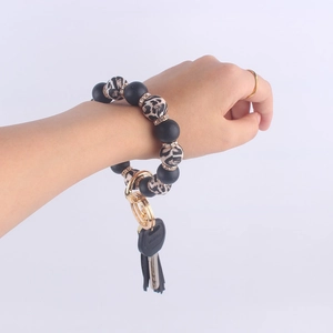 Close-up of silicone beaded wristlet keychain with leopard print and black tassel charm