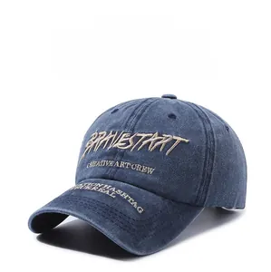 Detailed embroidery on vintage washed navy blue denim baseball cap with creative text