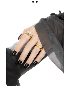 Detail of S925 silver irregular hollow rings with freshwater pearls and two-tone finish